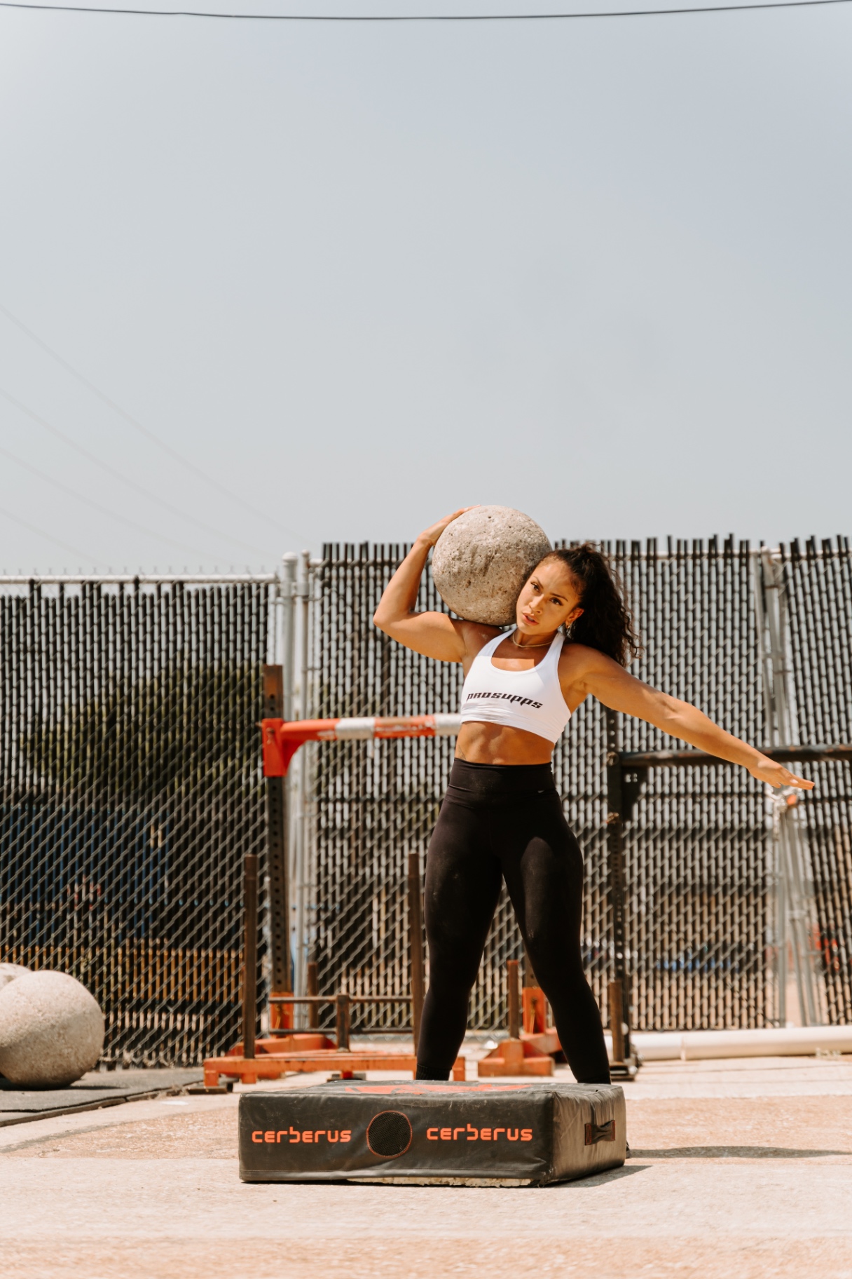 LabellaBeast founder shouldering an atlas stone during strongman training